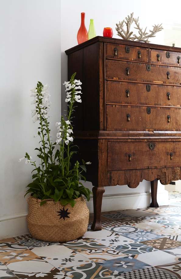 Chest of draws next to seagrass belly basket with plant