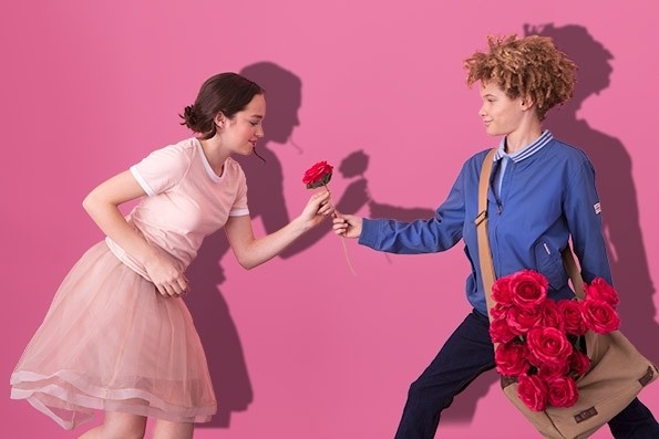 boy giving pink girl rose